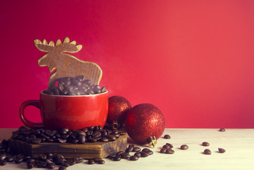 hot cup of coffee and xmas deer and glitter ball