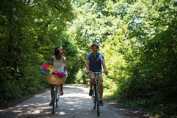 Young multiethnic couple having a bike ride in nature