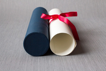 Focused university diploma with red bow and case