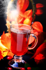 hot drink rosehip on wooden background retro rustic style physalis in a basket