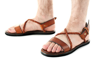 Brown leather sandals on man's feet isolated on white