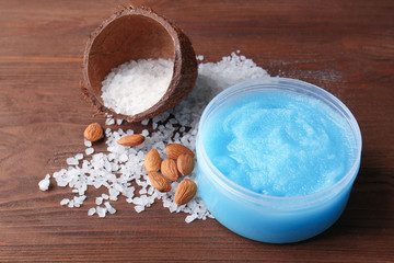 Body scrub, almond and salt on wooden background