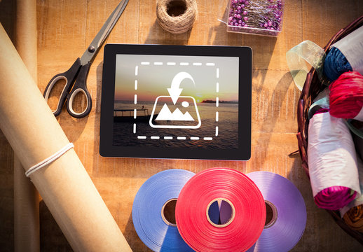 Tablet on Table with Wrapping Supplies Mockup 1