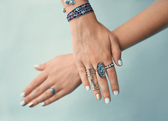 Female hands with jewelry on color background