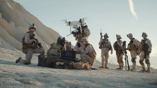 Soldiers are Using Drone for Scouting During Military Operation in the Desert. Slow Motion.