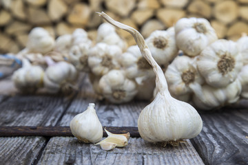 cloves of garlic on the wood background.