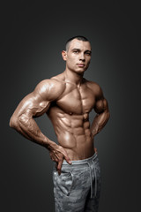 Fototapeta na wymiar Strong Athletic Man Fitness Model Torso showing six pack abs.