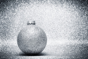 Christmas glass balls decoration on silver glitter background
