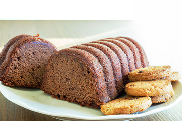 Chocolate Loaf cake, cookies and milk on a plate