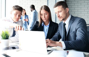 startup business team on meeting in modern bright office interior brainstorming, working on laptop and tablet computer