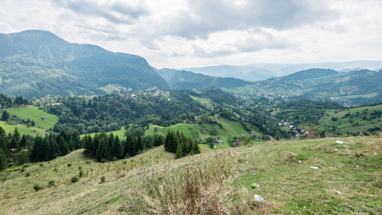 View to the carpathian mountains and romanian village from the t