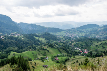 View to the carpathian mountains and romanian village from the t