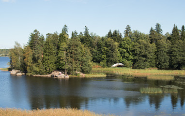 Landscape with the river in the sunny day. Water of deep blue color.
