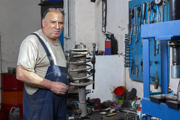 portrait of an elderly mechanic