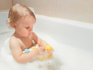 little 1,5 year-old baby boy playing in bath