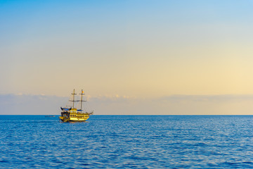 Sailing ship with tourists at sunset
