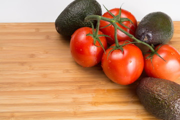 Fresh red tomatoes on a branch. Tomatoes with water drops.