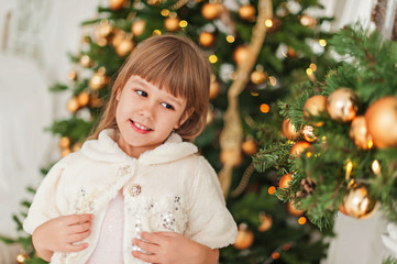 the girl at the Christmas tree with toys