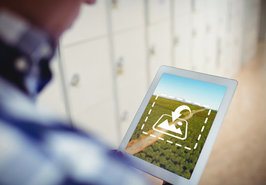 User with Tablet in Locker Room Mockup