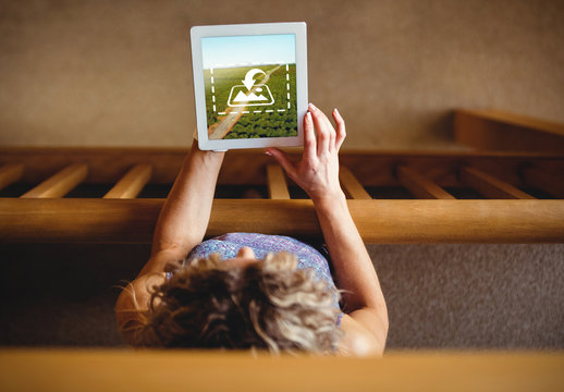 Woman Using Tablet on Wooden Railing Mockup