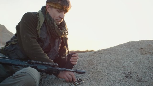 Terrorist reloading his Assault Rifle Magazine.