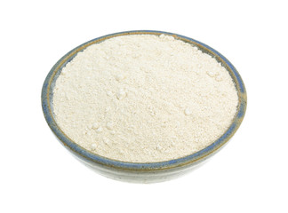 Quinoa flour in a bowl on a white background.