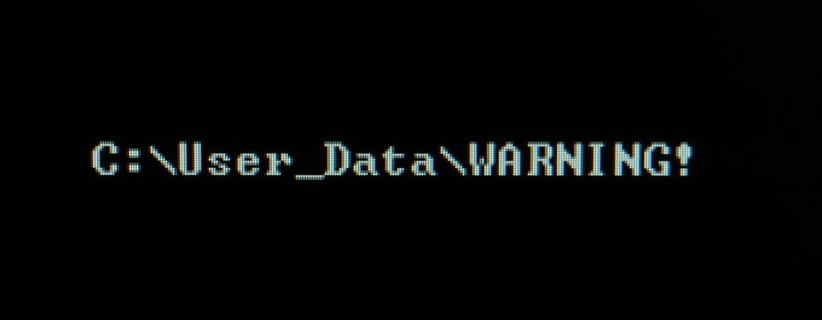 Computer screen shot of black background and white warning security text