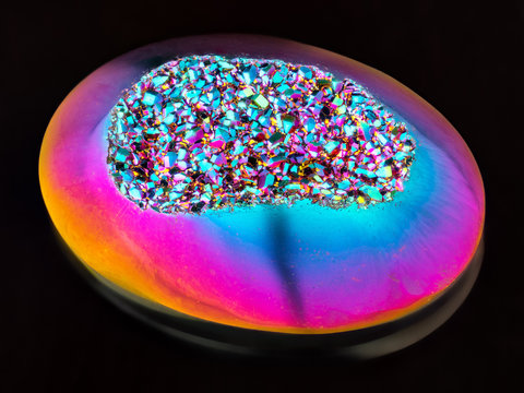 Extreme sharp Titanium rainbow aura cabochon gemstone taken with macro lens stacked from many images into one very sharp image.