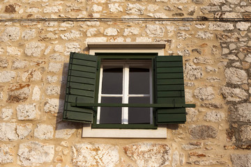 Fototapeta na wymiar Window on authentic dalmatian building in Stari grad, Hvar island - Croatia
