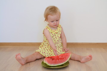 Little baby girl eating watermelon