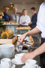 Waitress Serving Coffee in Buffet Restaurant