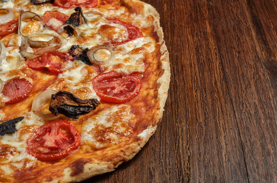 Delicious pizza with mushrooms and cheese on wood table