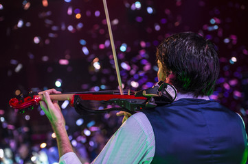violinist playing the electric violin concert © karrastock