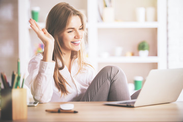 Smiling lady using laptop computer