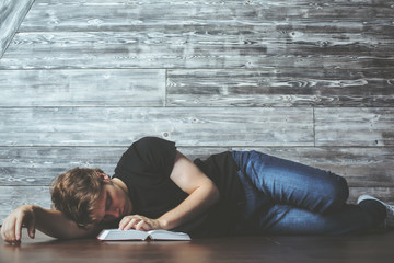 Man with book sleeping on floor
