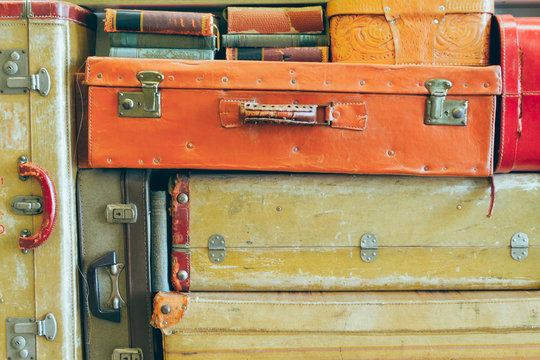 Antique suitcases stacked with old books
