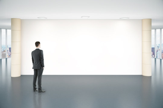 Man looking at blank wall