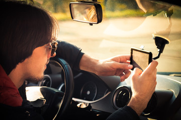 young man in car use gps