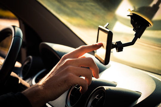 Man  Adjusting  Gps In Car