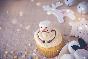 Fun homemade melting snowman cupcakes for kids, toning copy space background
