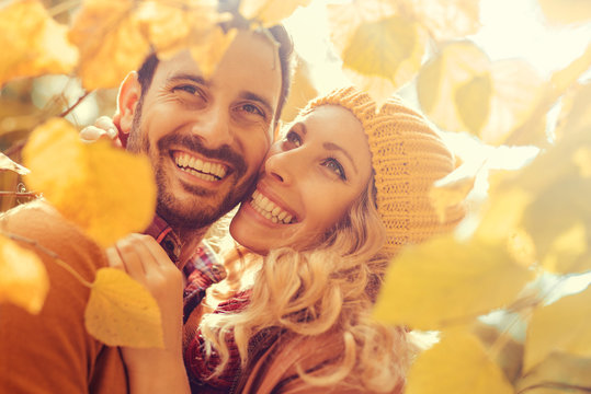 Loving couple smiling and enjoying the autumn season
