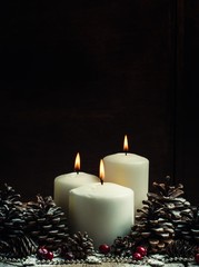 Christmas or New Year's composition with burning white candles,