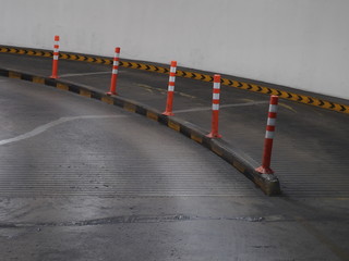 traffic pole with reflective tape in middle of path way parking