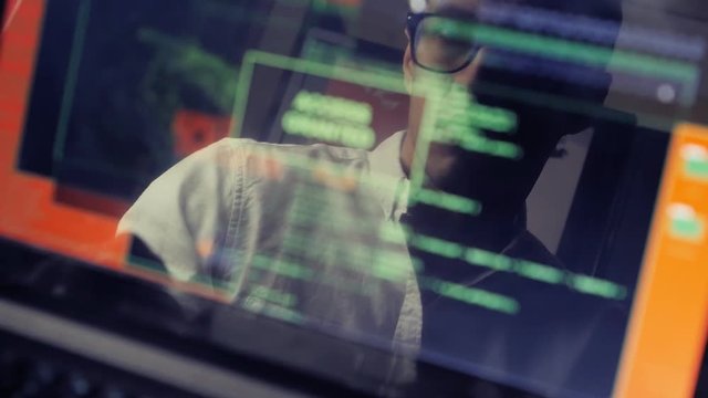 double exposure shot of man hacker working at a laptop