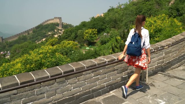Great Wall of China. Tourist on Asia travel walking on famous Chinese tourist destination and attraction in Badaling north of Beijing. Woman traveler hiking great wall enjoying her summer vacation.