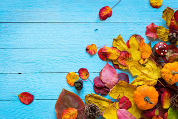 Colorful autumn leaves, over a wooden background