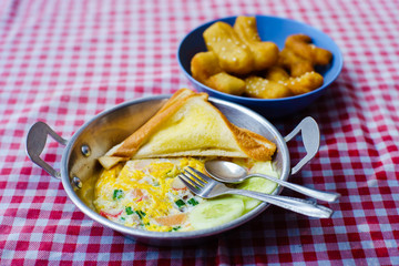 pan-fried egg with deep-fried dough stick with hot tea, breakfast, chiangrai thailand