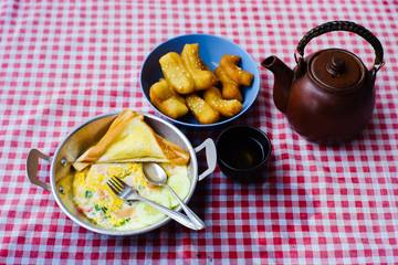 pan-fried egg with deep-fried dough stick with hot tea, breakfast, chiangrai thailand