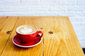 late art in red cup on wood table look delicious