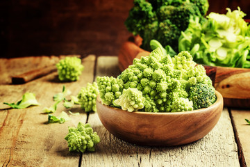 Green cauliflower, old wooden background, selective focus